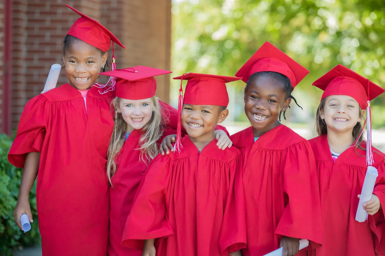 Children wearing red graduation outfits